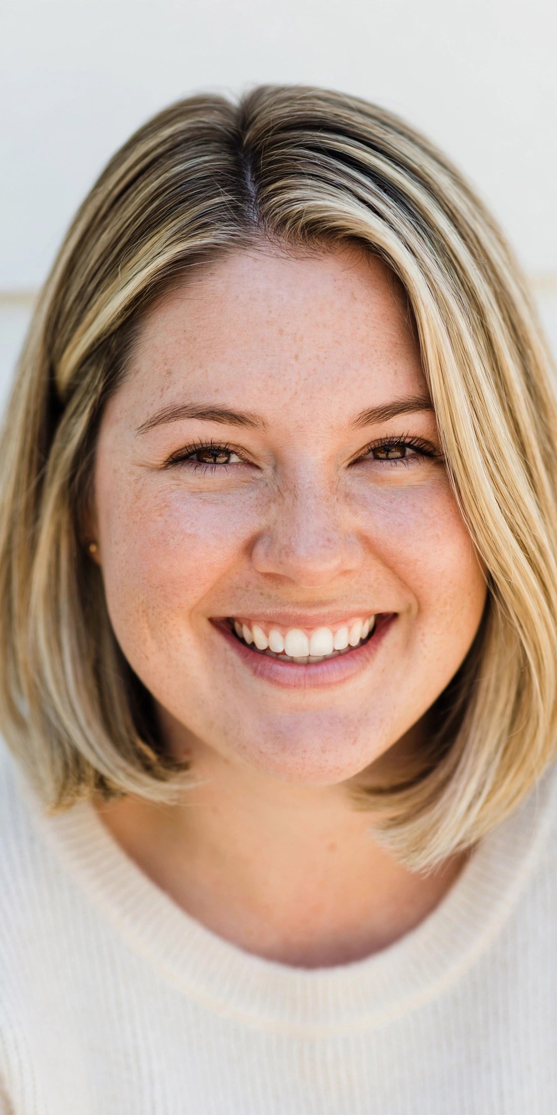 Woman with a round face wearing a jaw-framing bob
